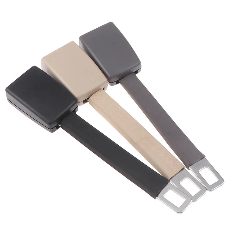 Three car seat belt buckle adapters in black, beige, and gray, arranged diagonally on a plain white background.