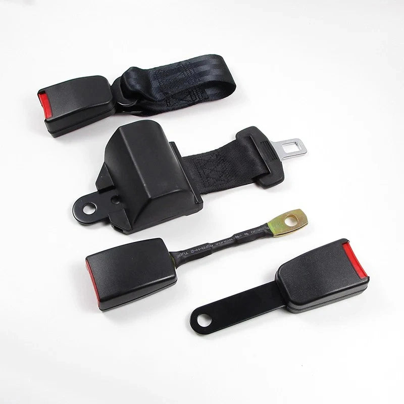 A set of four black automotive seat belt components, including buckles, straps, and release mechanisms, arranged on a plain white background.