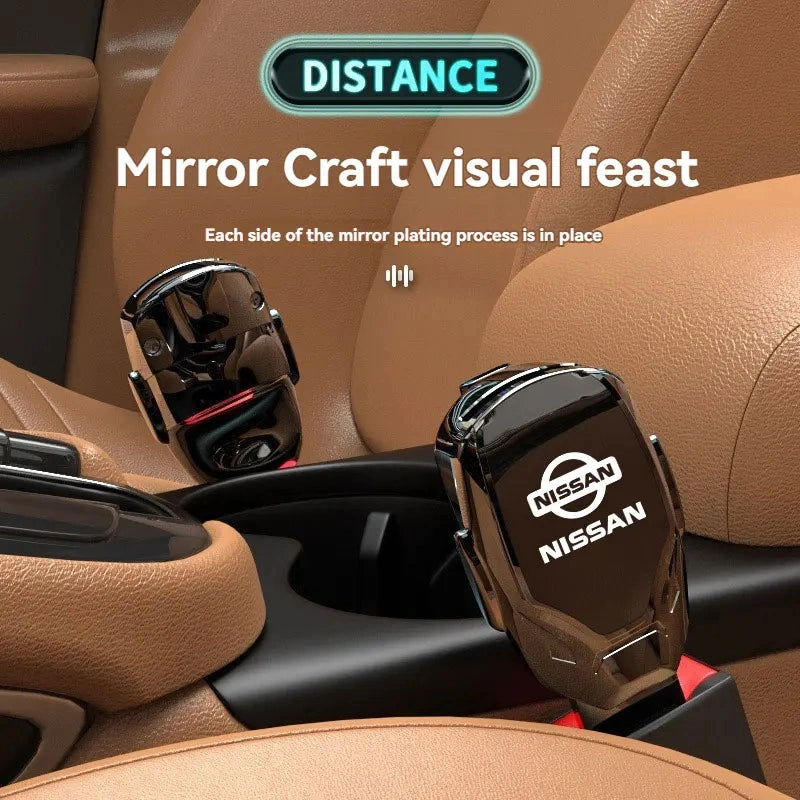 Two Nissan branded mirror-chrome seat belt extenders installed in car center console