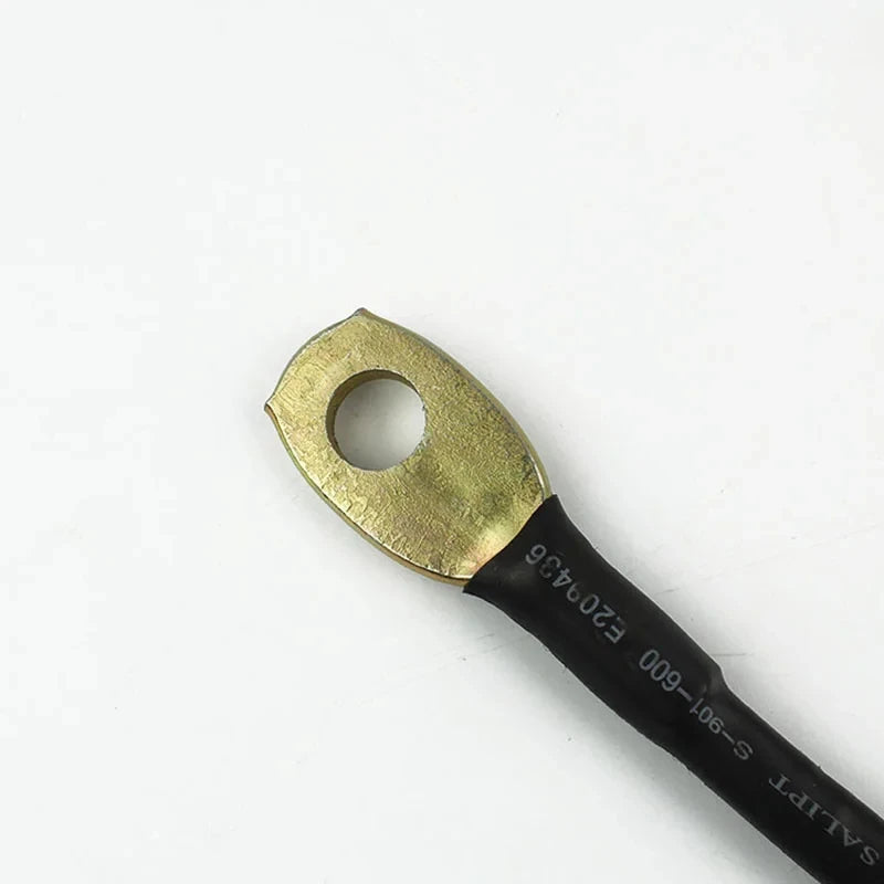 Close-up of brass ring terminal mounting eyelet on black flexible wire stem seat belt buckle receiver