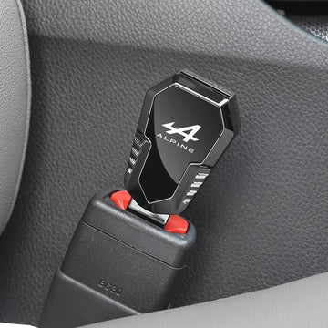 Alpine metal seat belt clip extender inserted into a car seat belt buckle inside the vehicle interior