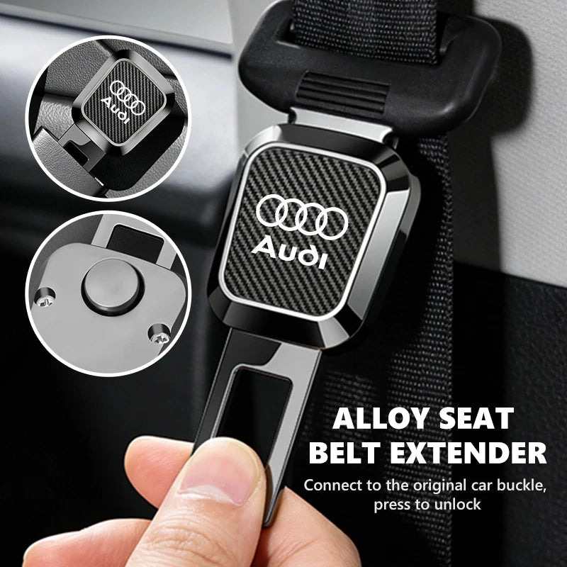 Hand inserting an Audi alloy seat belt extender with black carbon fiber pattern into a car seat belt socket