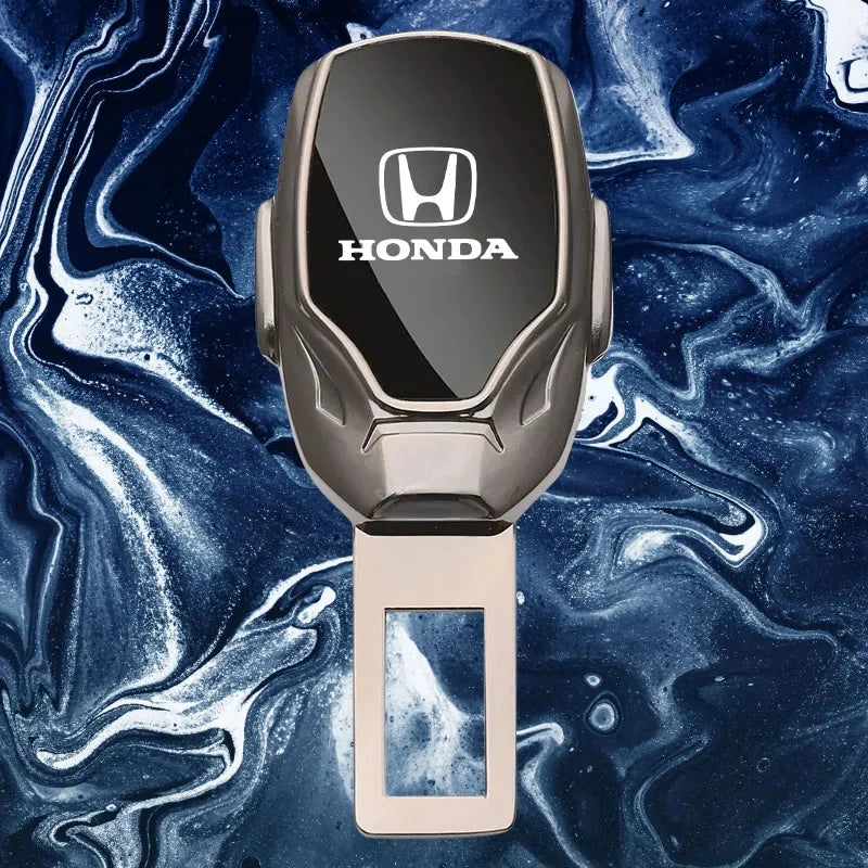 A custom metallic Honda key fob with a black glossy top panel and a rose gold lower body, set against a blue and white marbled background.