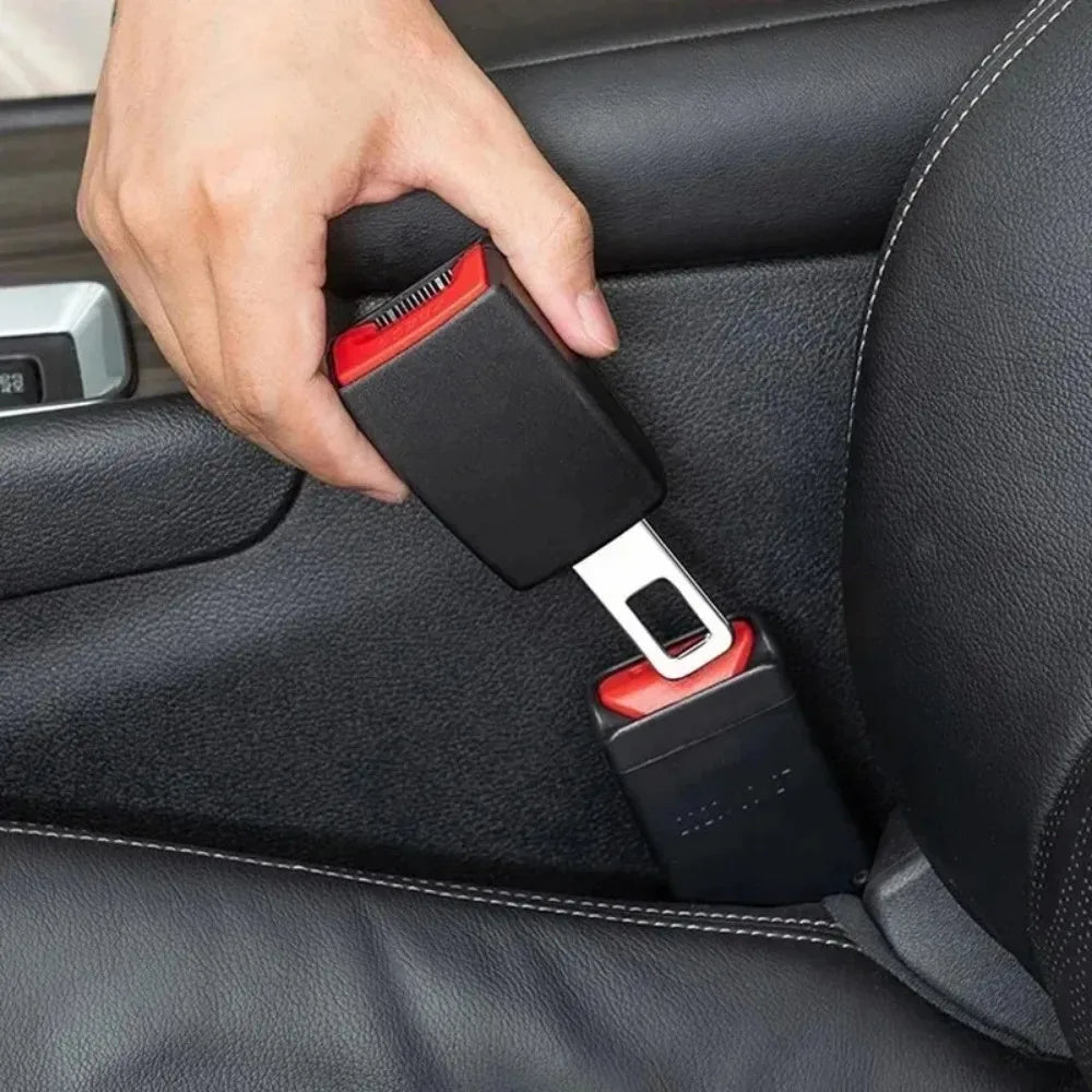 Hand inserting a black seat belt extender into a car seatbelt buckle receiver