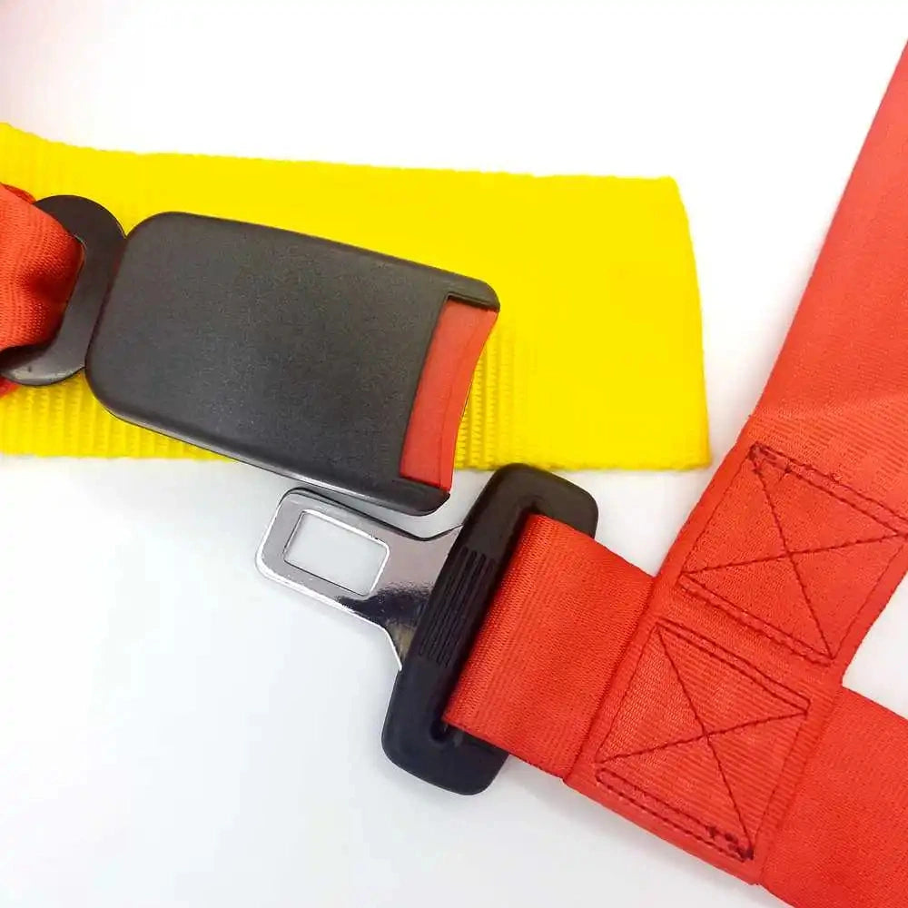 Red 4-point racing harness quick-release buckle mechanism with reinforced high-strength nylon stitching.